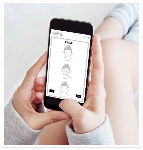 A person holding a smartphone A person holding a smartphone while sitting with their legs bent, viewing a website showing facial treatment options titled “FACE” with illustrations labeled “Active Contouring,” “HydraFacial,” and “Inject.”